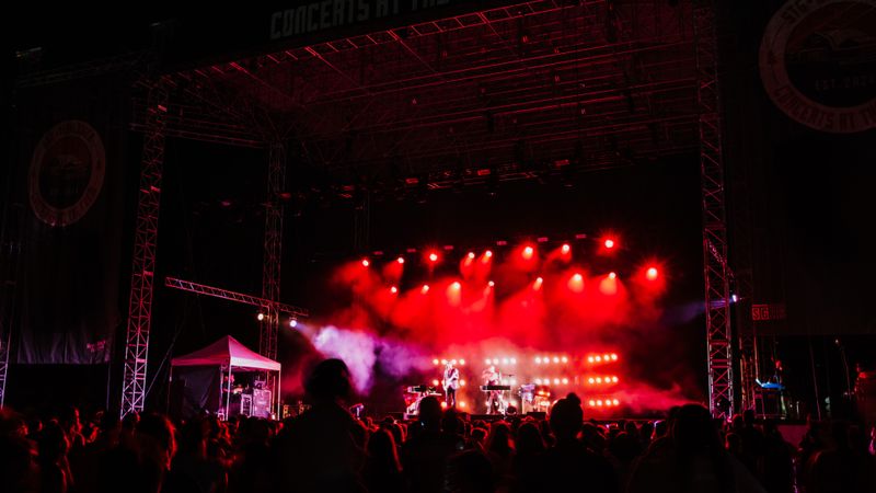 Energetic concert night at Seattle's iconic outdoor venue. Captivating music, lively crowd under bright stage lights.