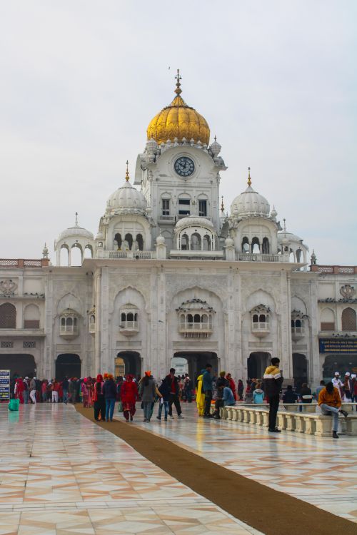 Free Visitors exploring the stunning architecture of the Golden Temple complex in Amritsar, India. Stock Photo