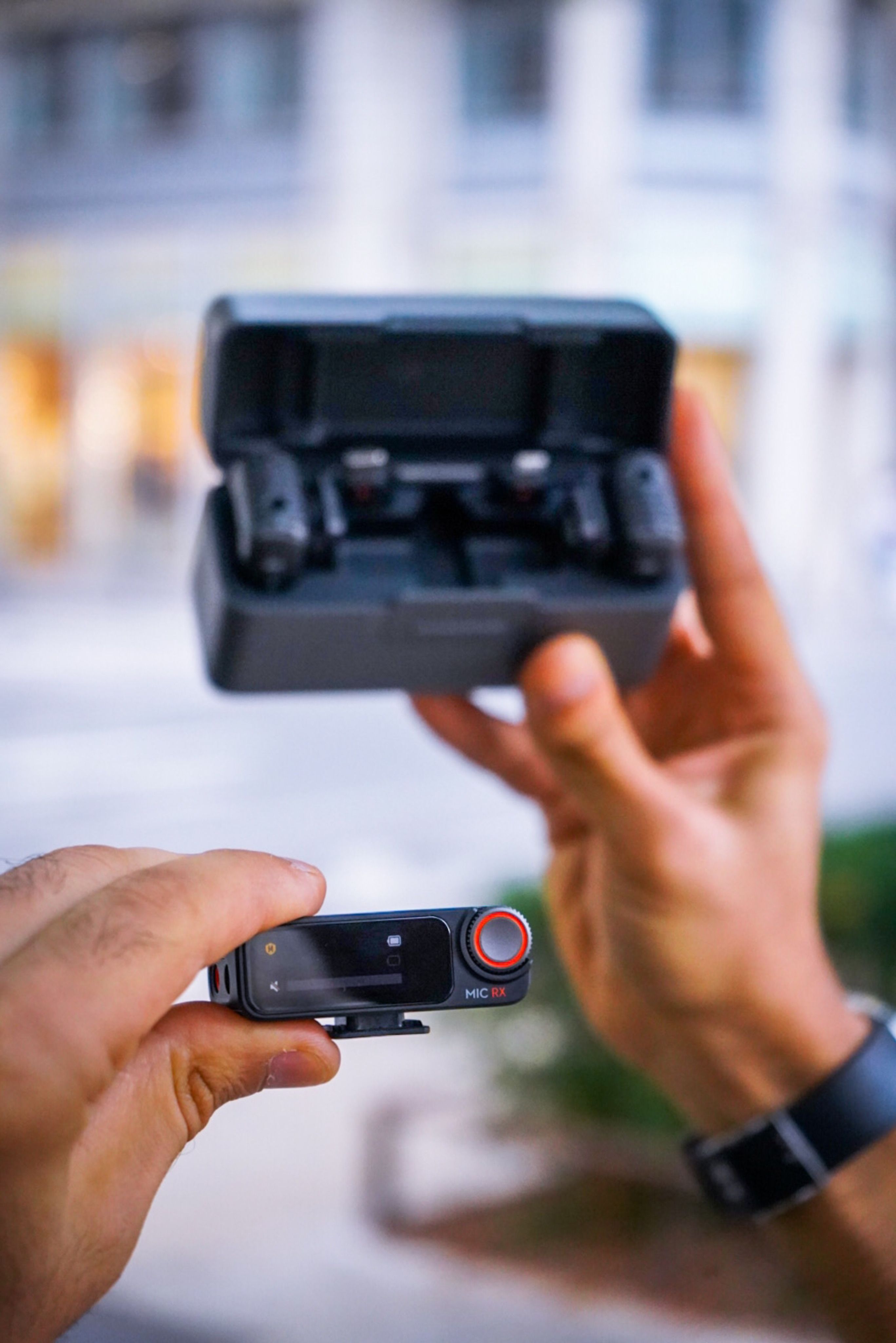 A person holding a small box with a camera · Free Stock Photo