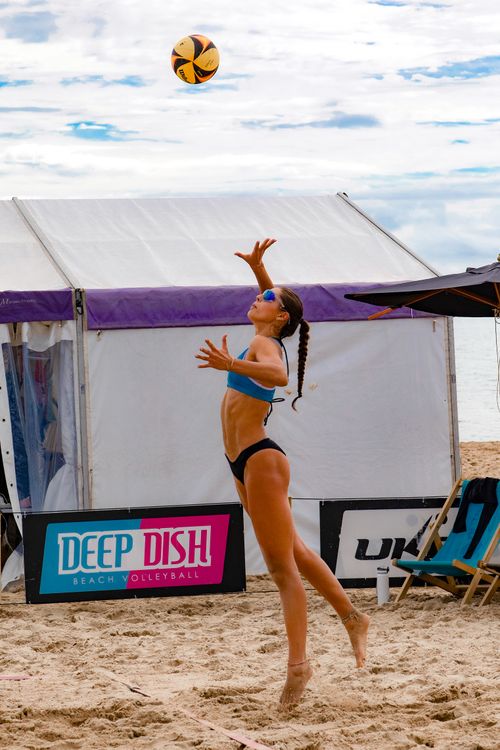 Free Action shot of a female volleyball player serving during a beach tournament in Bournemouth, UK. Stock Photo