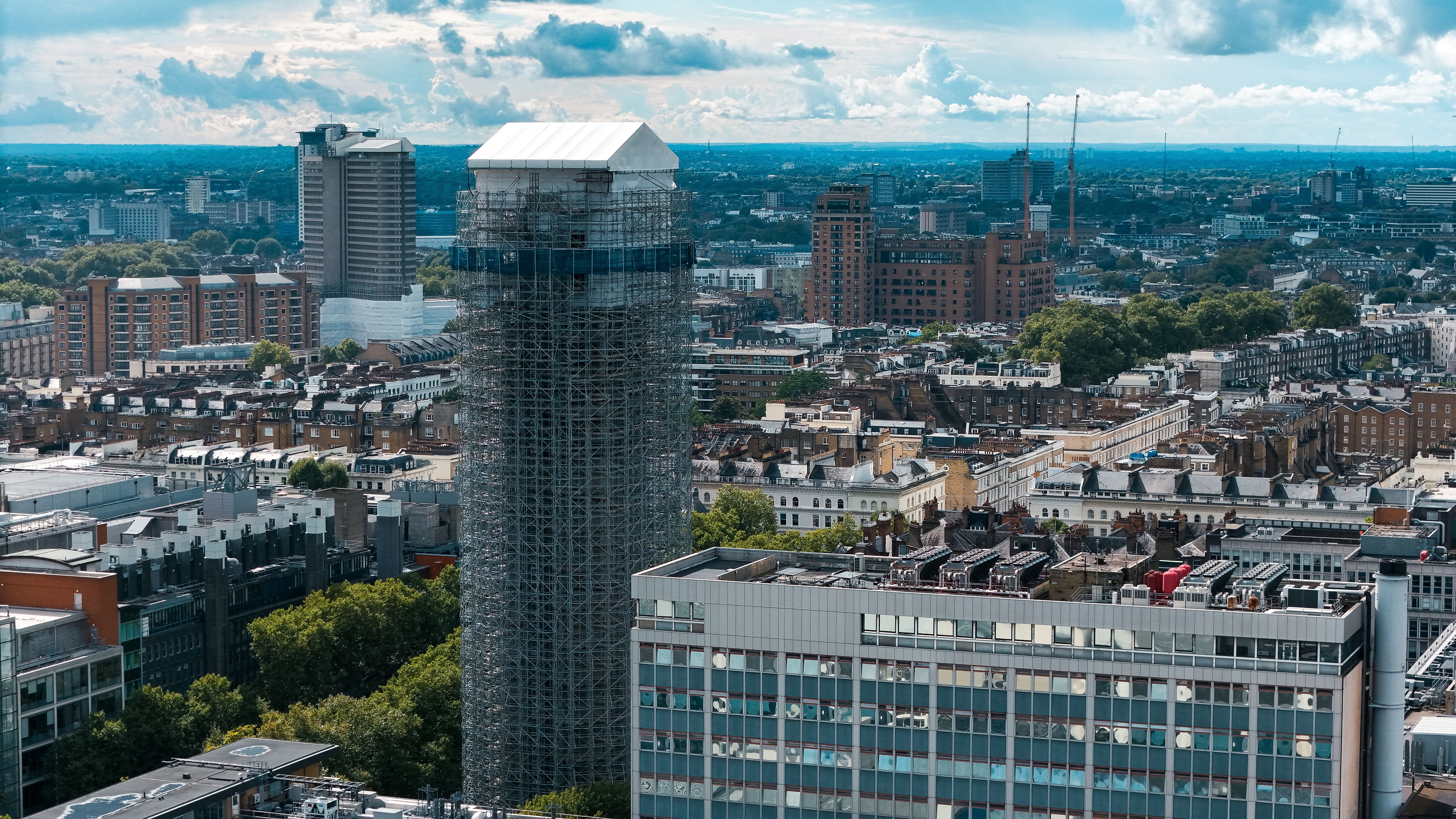 A scenic aerial view of London's skyline featuring urban architecture and a building under renovation.