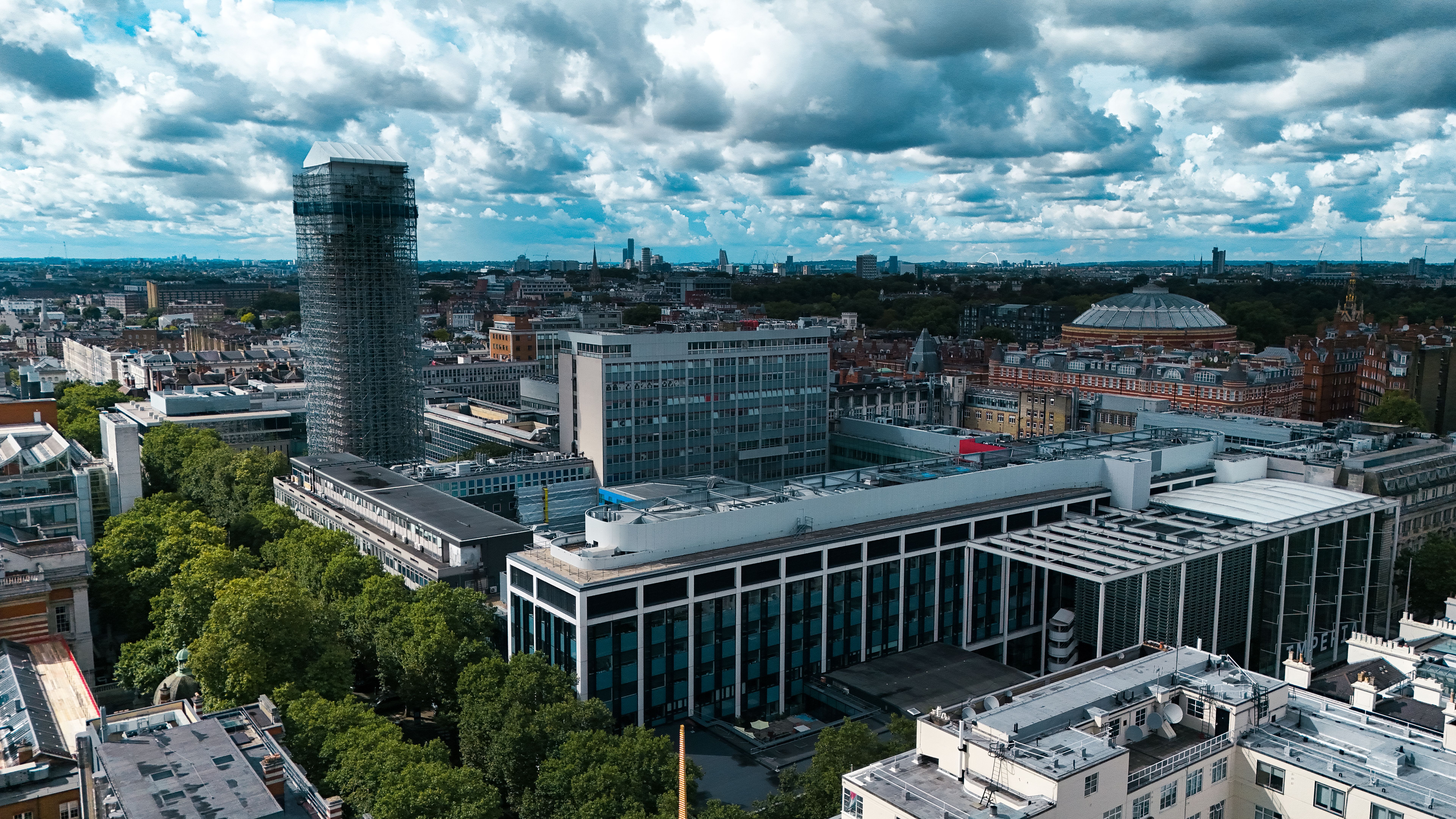 Stunning London cityscape showcasing modern architecture and lush greenery from above.