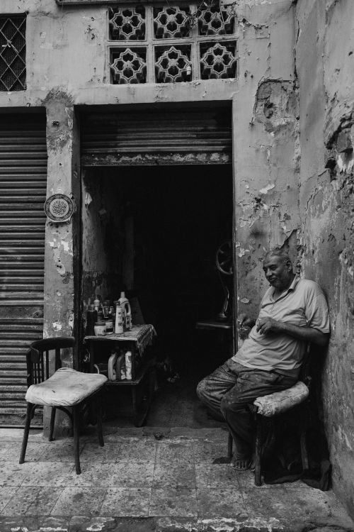 Free A man resting outside a shop in old Alexandria, Egypt. Stock Photo