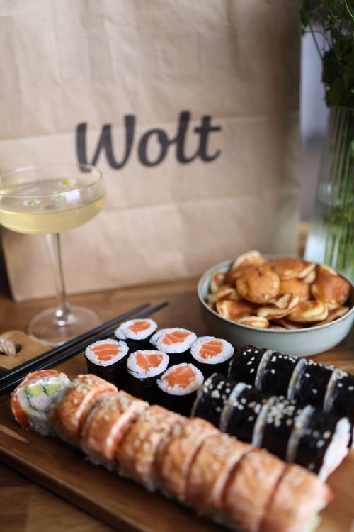 Free A vibrant sushi platter with a glass of champagne and snacks on a wooden table, perfect for dining. Stock Photo