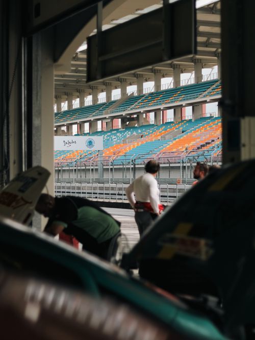 Free Captivating view of a pit stop at a racing circuit with an empty grandstand in the background. Stock Photo