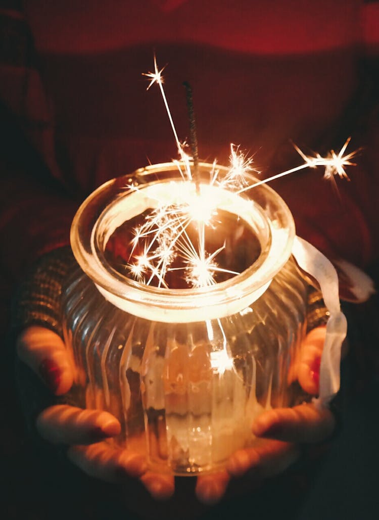 Person Holding Jar With Sparkler