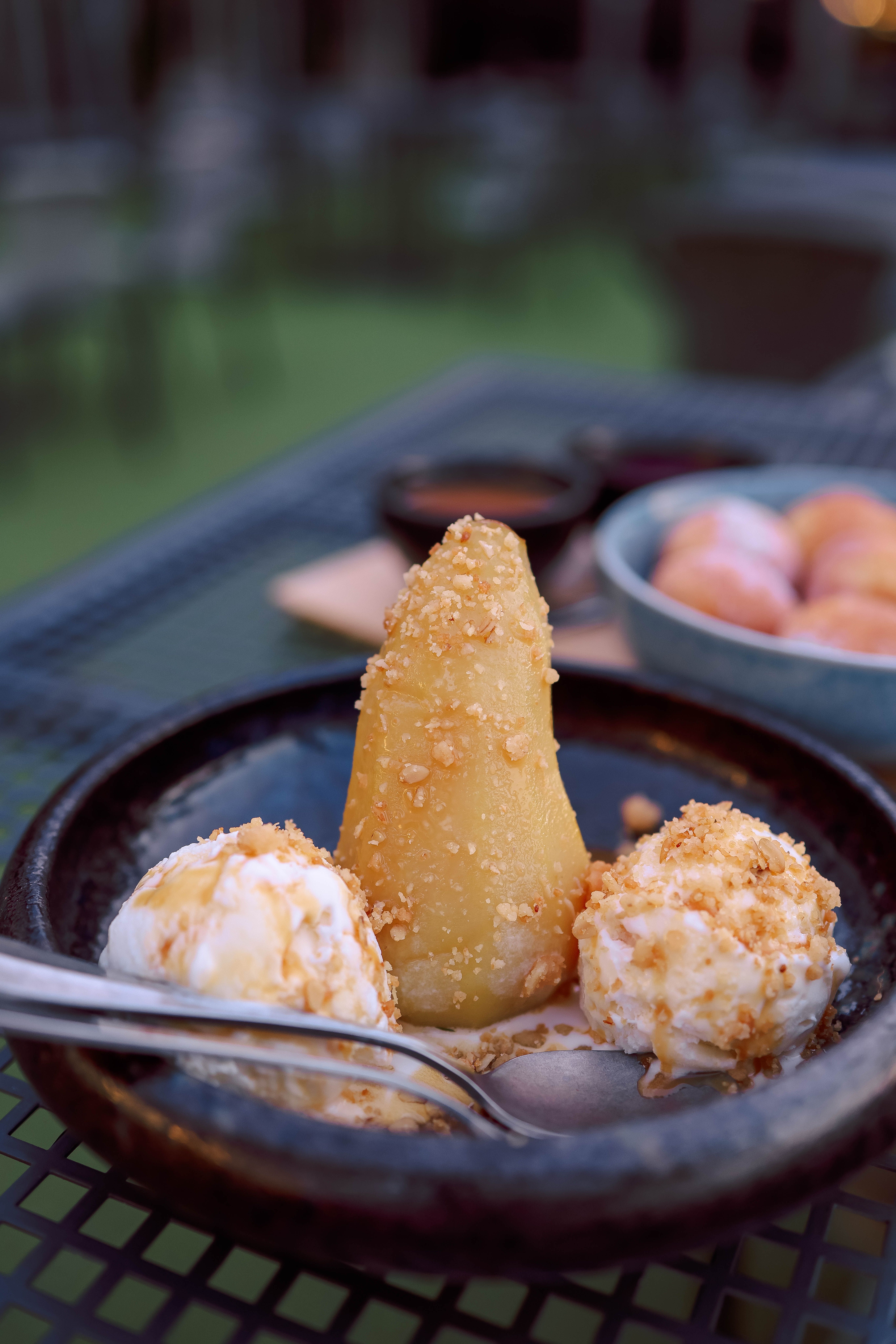 A dessert with ice cream and fruit on a table · Free Stock Photo