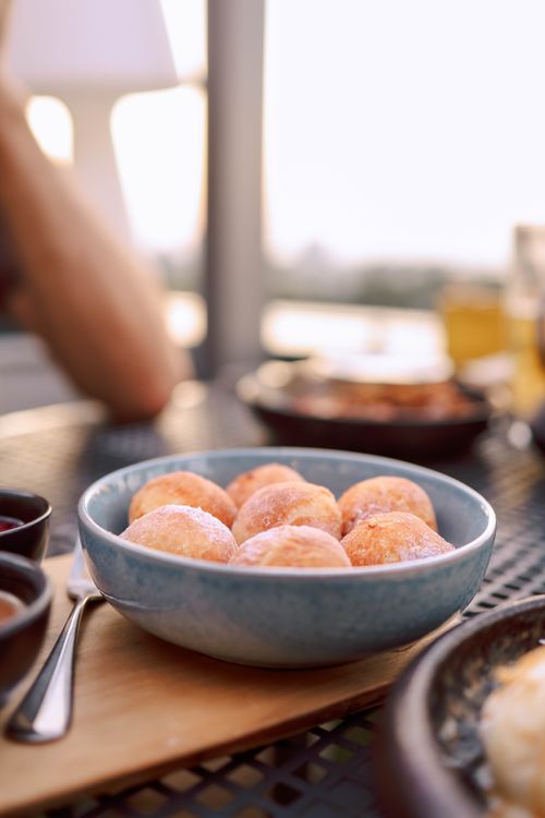 Free Delicious breakfast scene with fresh pastries on a table during a picturesque dawn. Stock Photo
