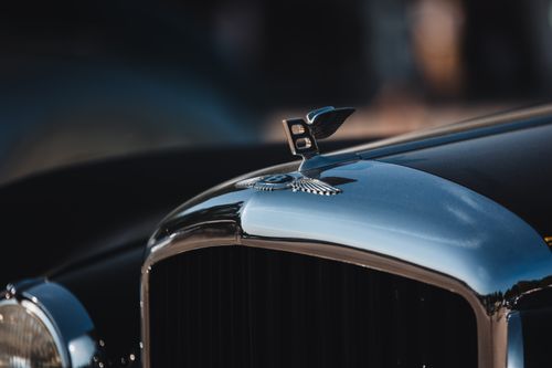 Free Close-up of a classic luxury car front, featuring chrome detail and a distinct emblem. Stock Photo