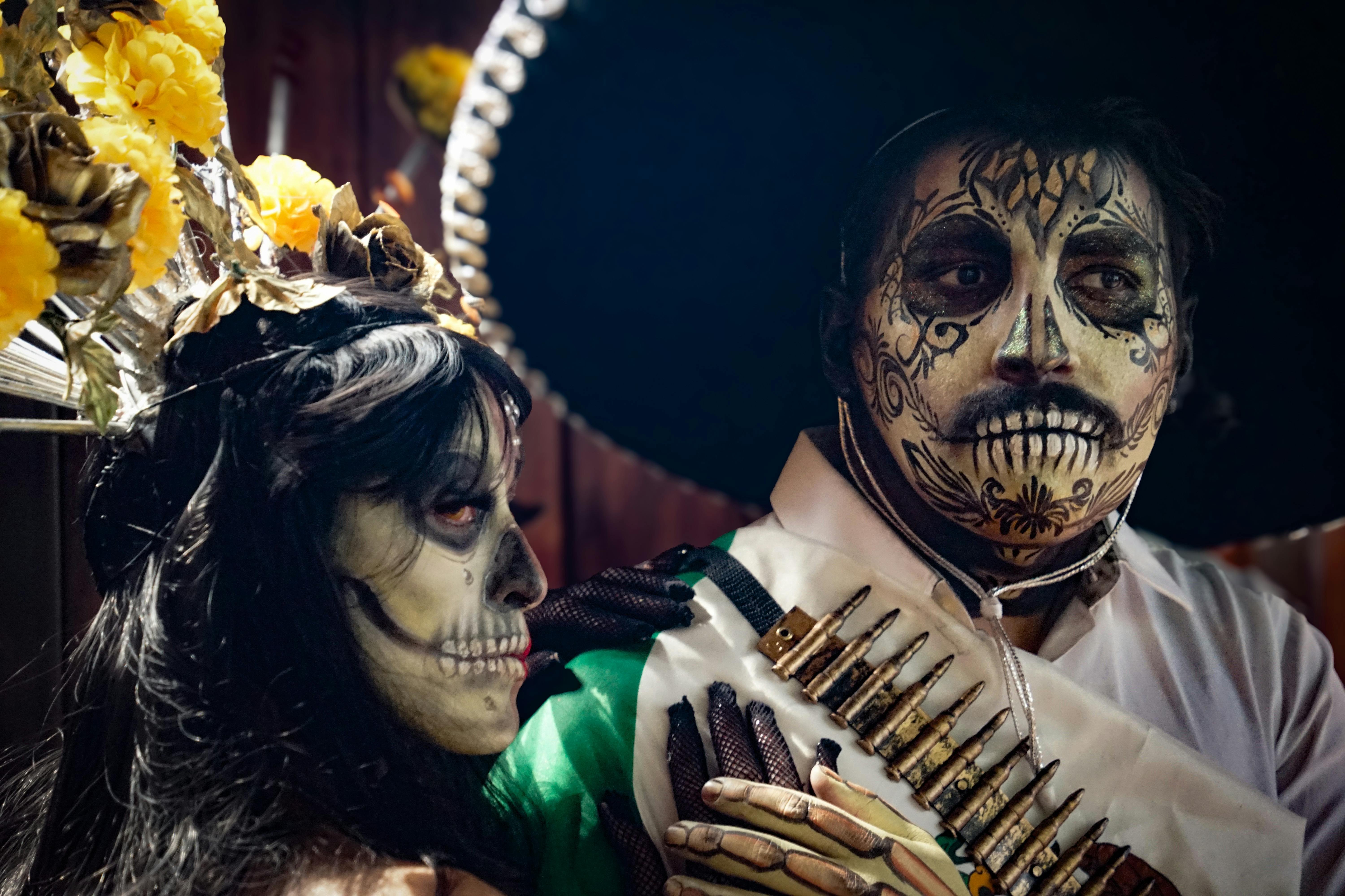 a man and woman dressed in mexican costumes