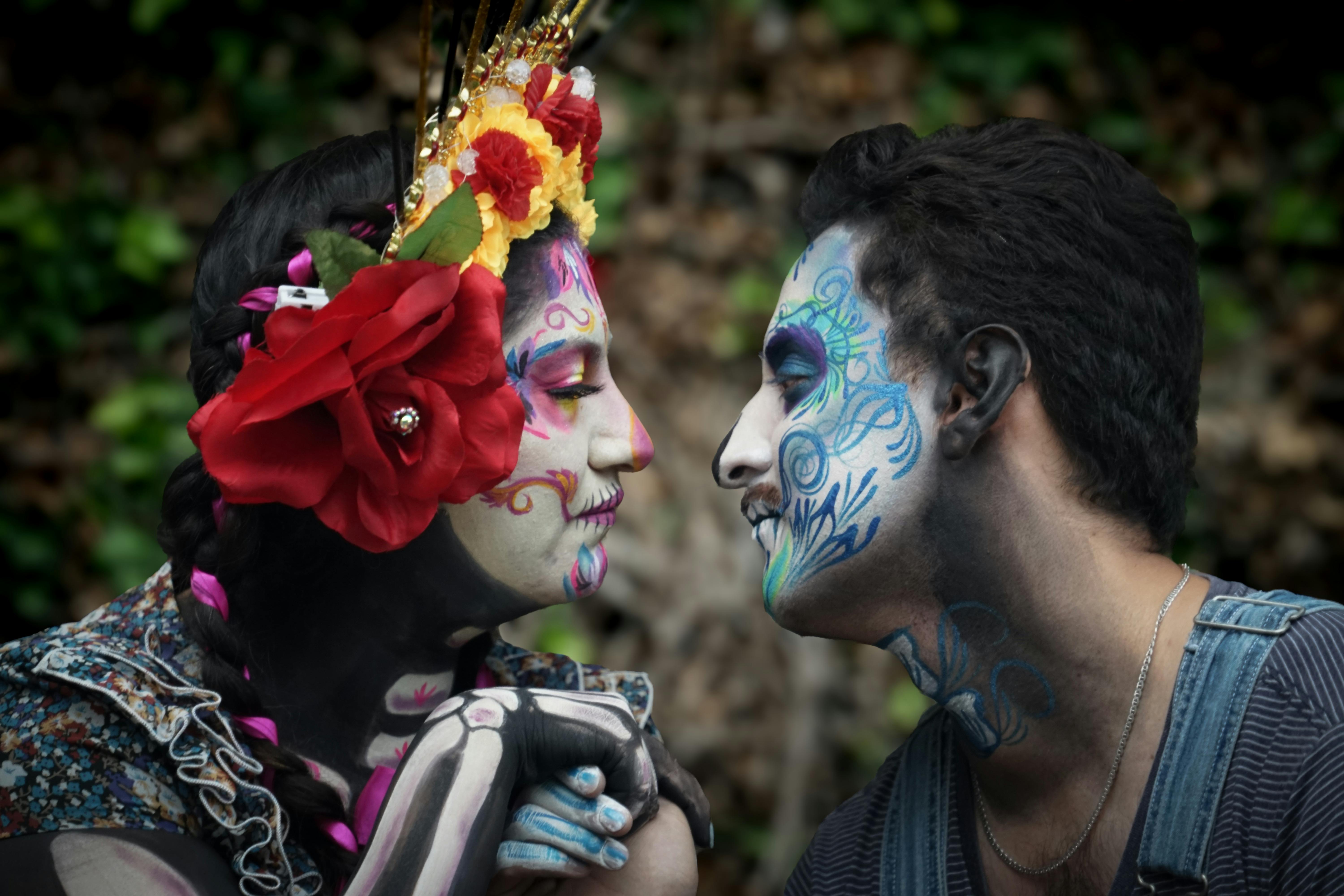 a couple with painted faces and flowers on their faces