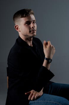 Portrait of a serious man in a dark jacket, sitting indoors