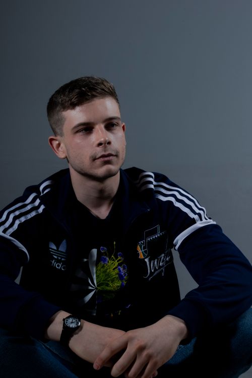 Free Portrait of a young man wearing a sport jacket in a studio setting indoors. Stock Photo