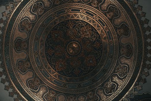Beautifully detailed ornate ceiling featuring geometric and floral patterns, ideal for design inspiration.
