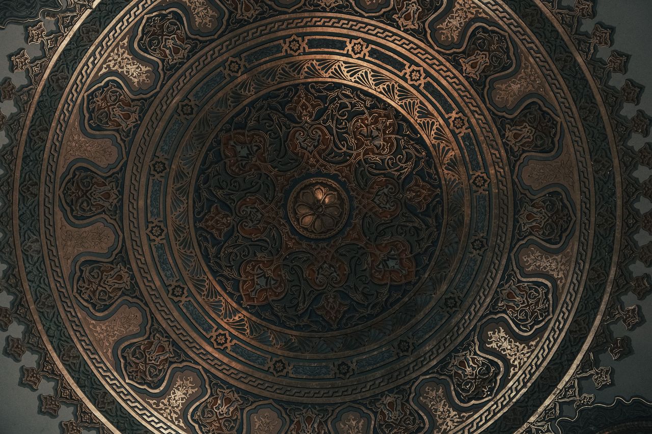 beautifully detailed ornate ceiling featuring geometric and floral pat