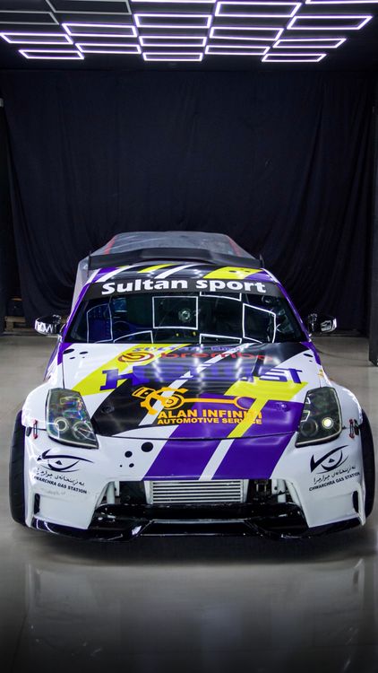 Custom Car Racing Custom Race Car in Showroom with Bold Graphics · Free Stock Photo