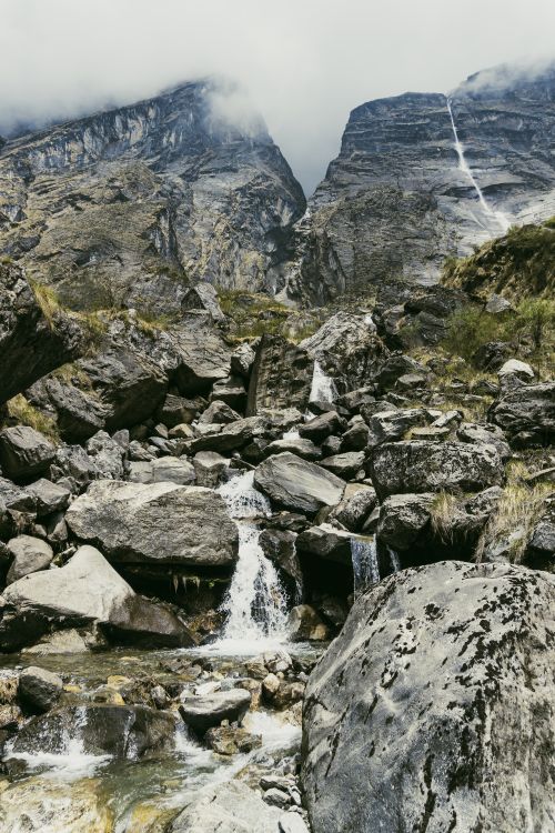 Free Breathtaking view of a rocky mountain landscape with cascading waterfalls in Ghandruk, Nepal. Stock Photo