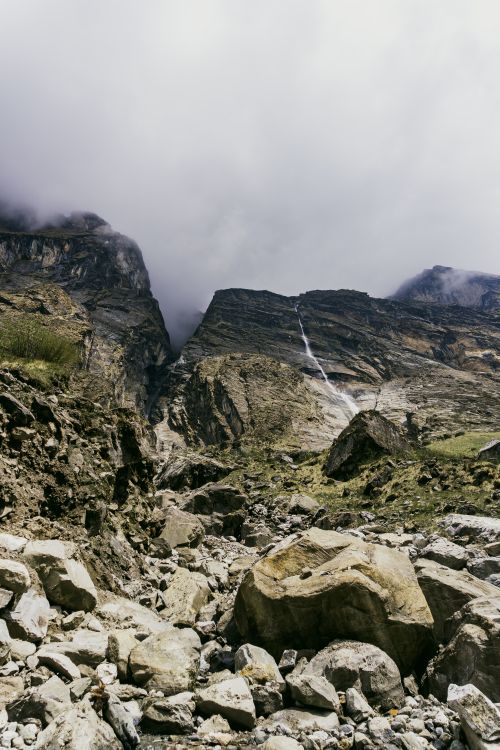 Free Dramatic view of a waterfall cascading down rocky mountains in Ghandruk, Nepal. Stock Photo