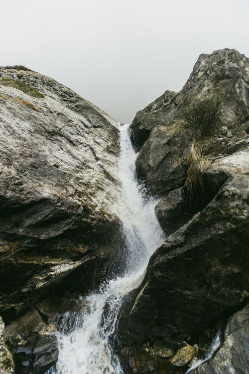 Free Peaceful waterfall cascading down rocky terrain in the Himalayas, Nepal. Stock Photo