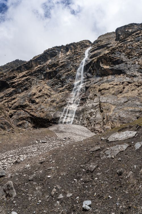 Free Explore the stunning waterfall cascading down rocky terrain near Ghandruk in the Gandaki Province, Nepal. Stock Photo
