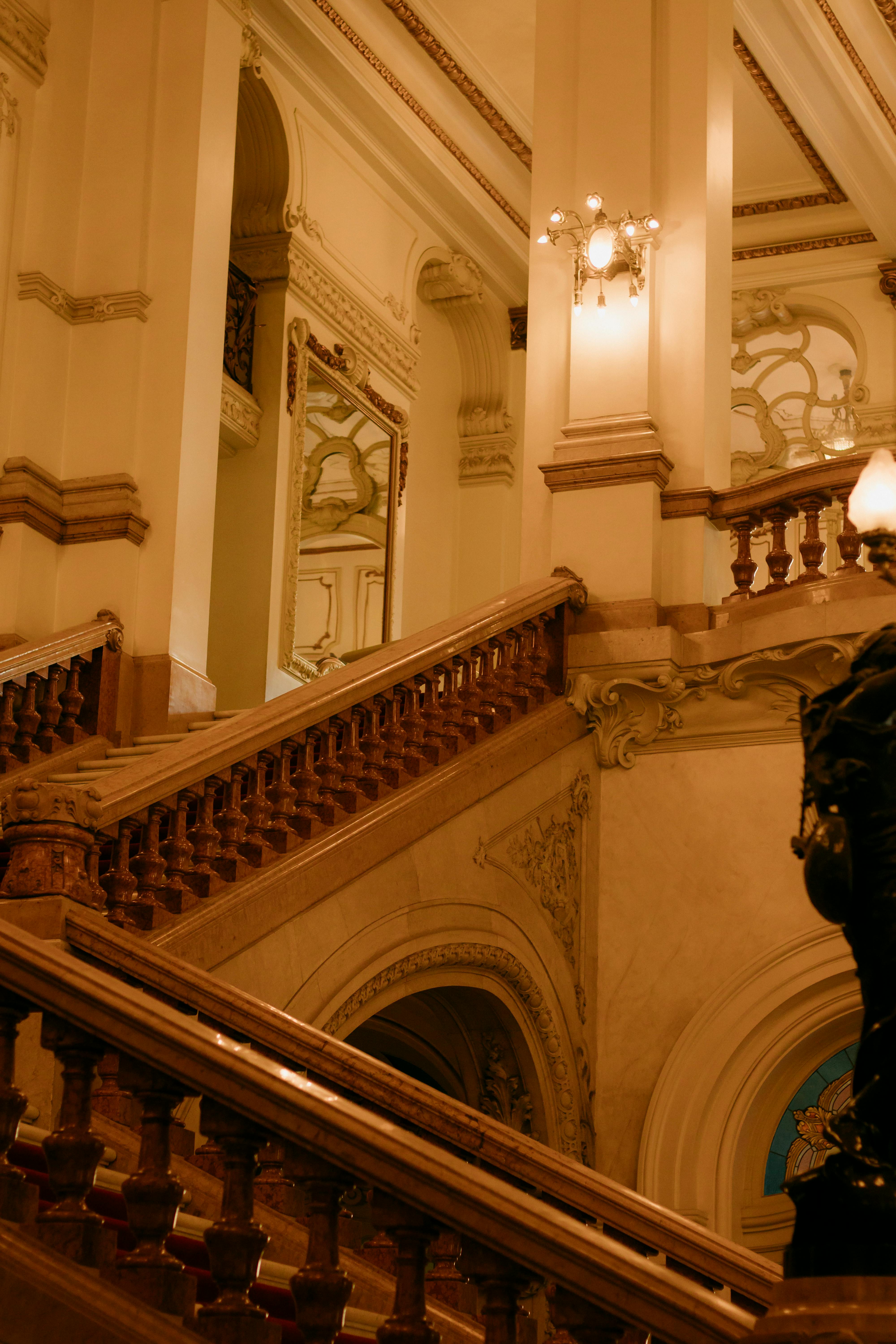 A grand staircase with ornate design elements in a historic building's interior.