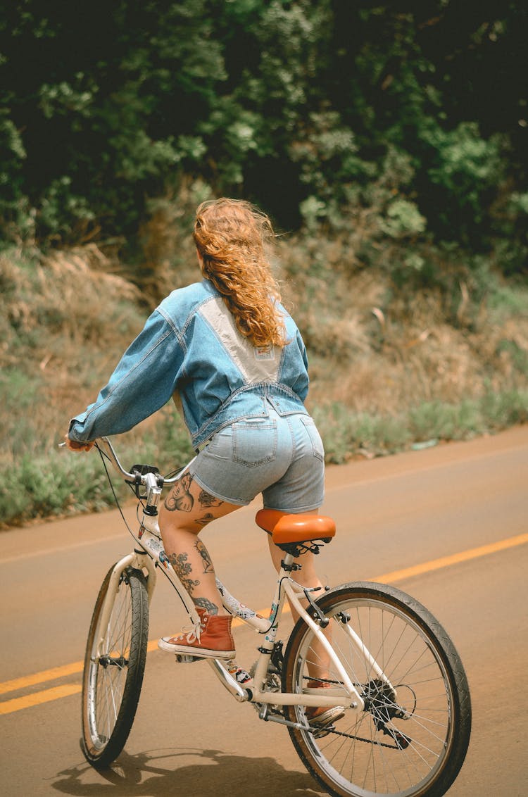 Woman Riding White Bicycle