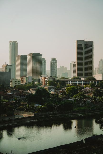Explore the modern skyline of Jakarta with its impressive buildings and serene waterfront.