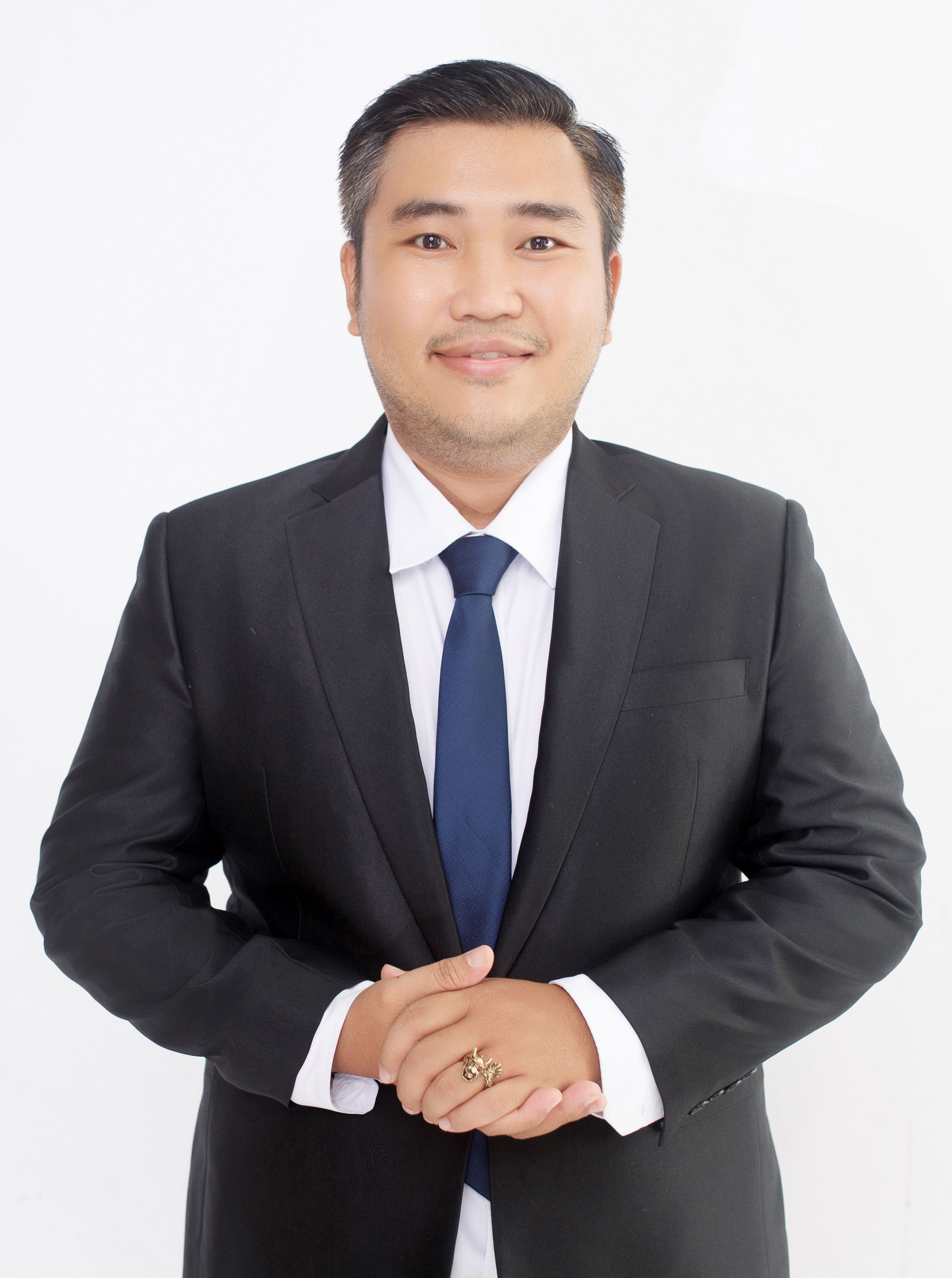 Portrait of a confident businessman in a suit with a friendly expression.