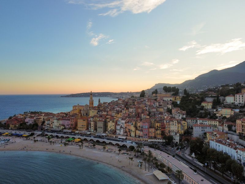 Menton's old town above the beach at sunset