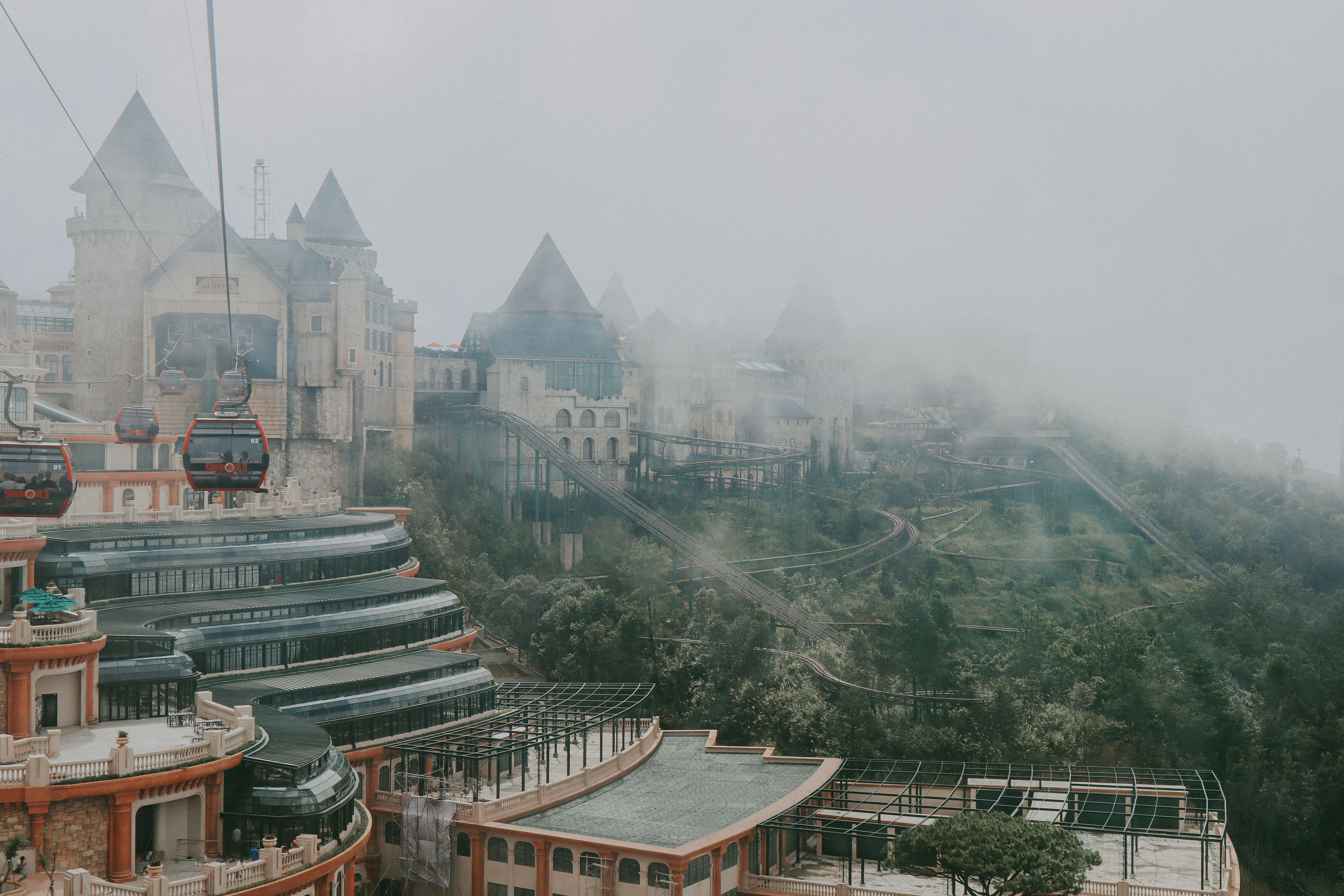 Capture of iconic French village in Ba Na Hills, Vietnam enveloped in mist and viewed from above.