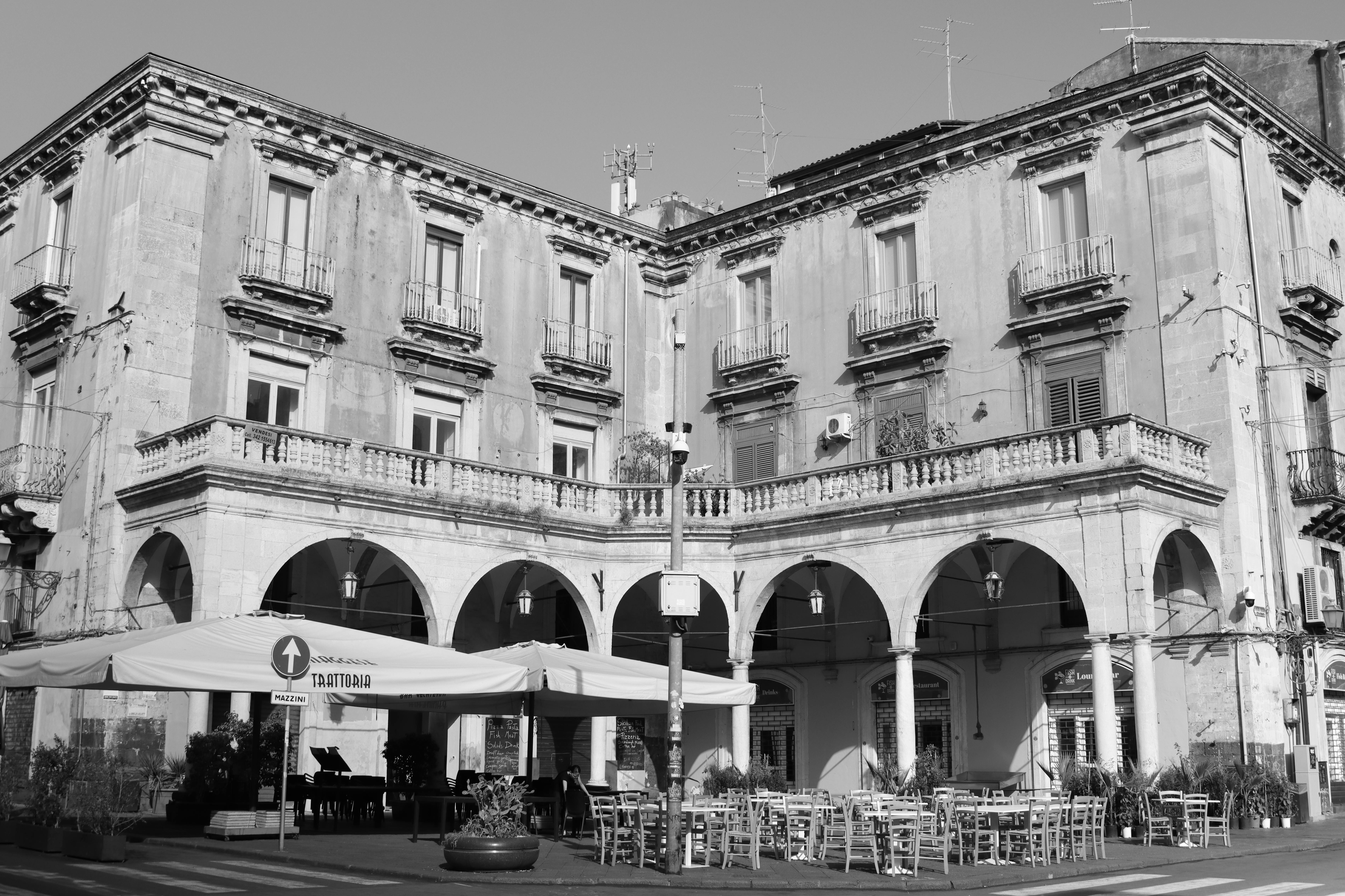 Free Elegant historic building with arches and outdoor cafe in Catania, Sicily. Stock Photo