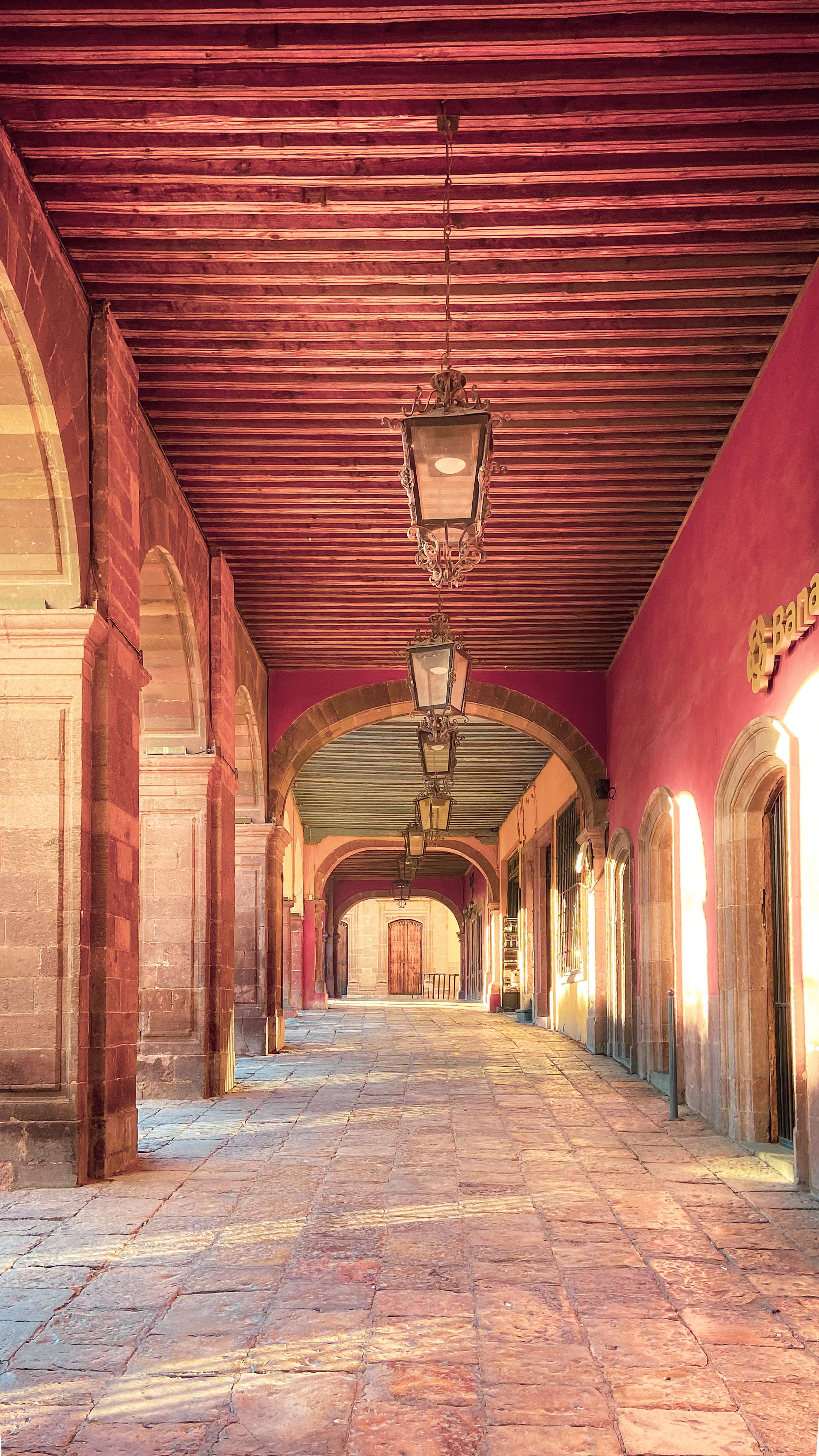 Explore the vibrant architectural beauty of colonial archways in San Miguel de Allende.