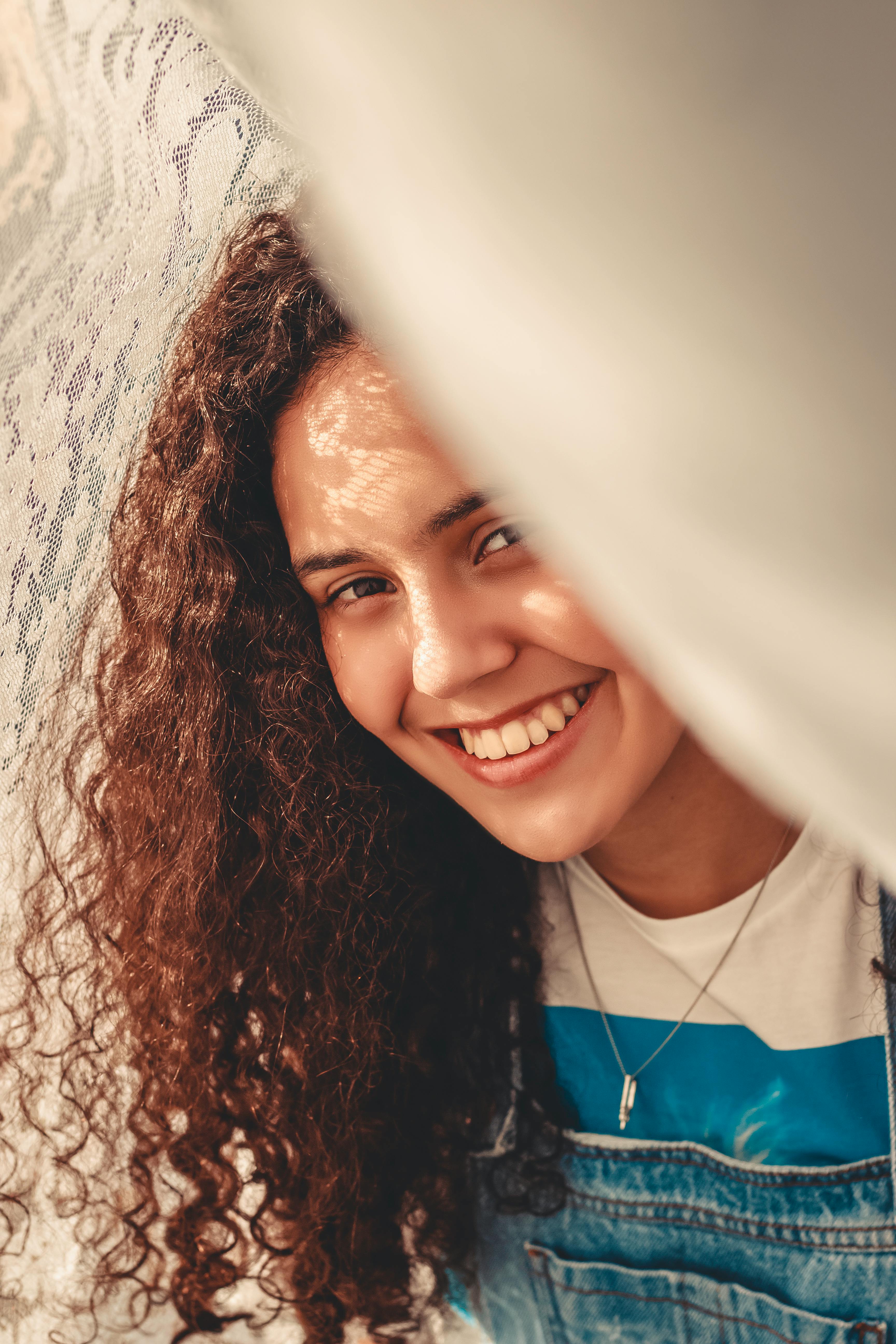 photo of woman beside lace fabric