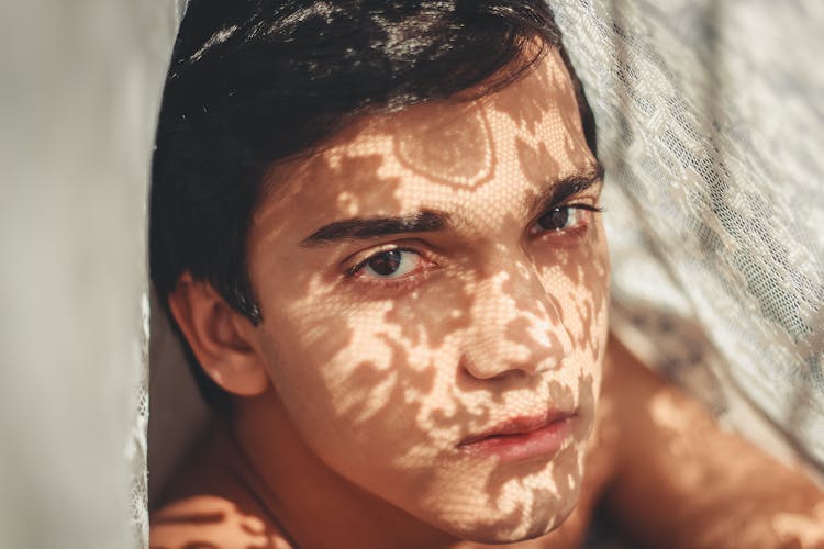 Photo Of Man Beside Lace Fabric