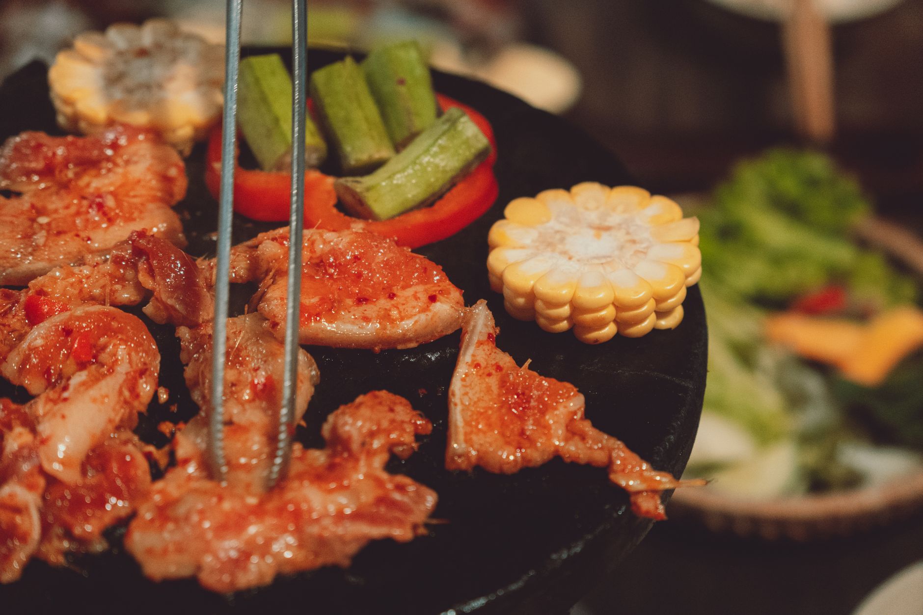 Delicious grilled meat and vegetables sizzling on a hot plate in Dalat, Vietnam.