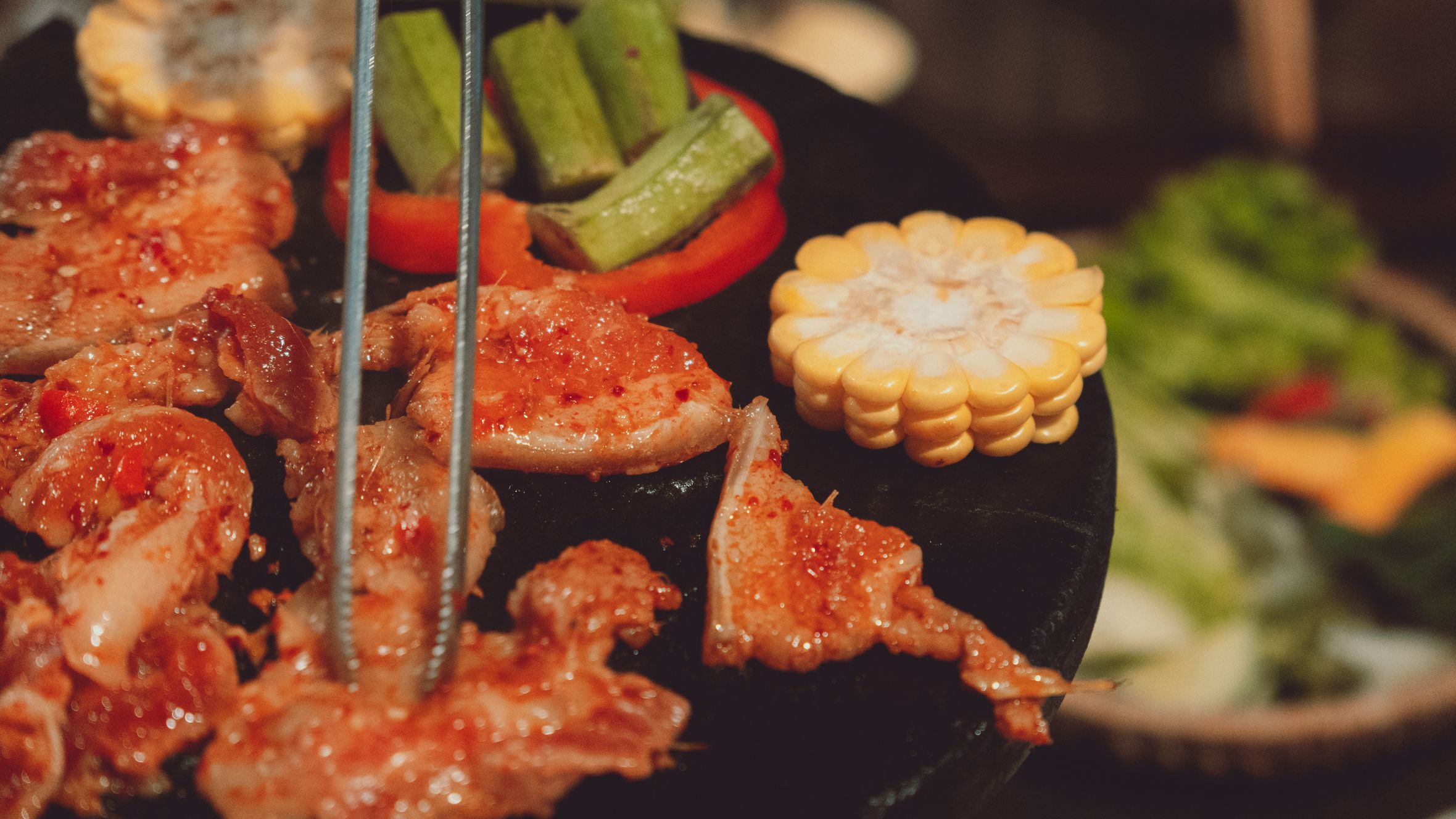 Delicious grilled meat and vegetables sizzling on a hot plate in Dalat, Vietnam.
