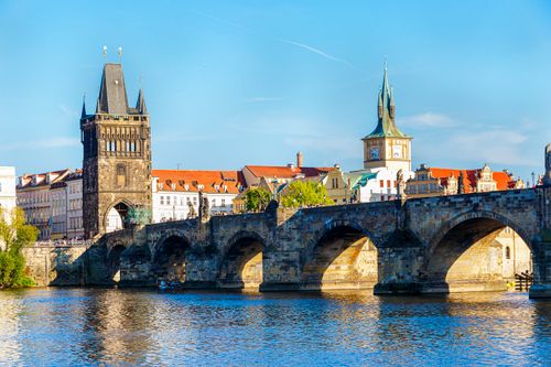 Free Stunning view of Charles Bridge and historic towers in Prague under a clear blue sky. Stock Photo
