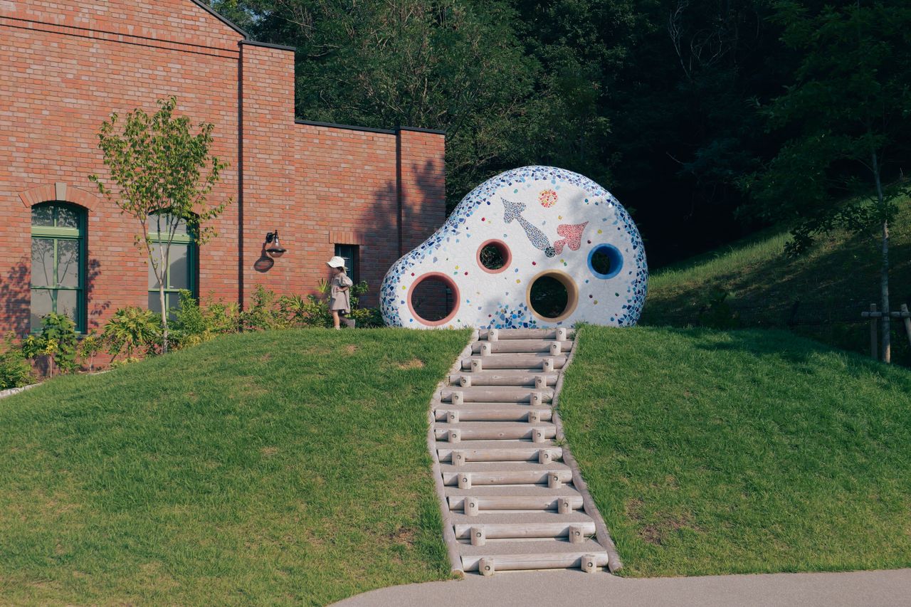 a park in nagoya japan with playful sculpture and grassy landscape