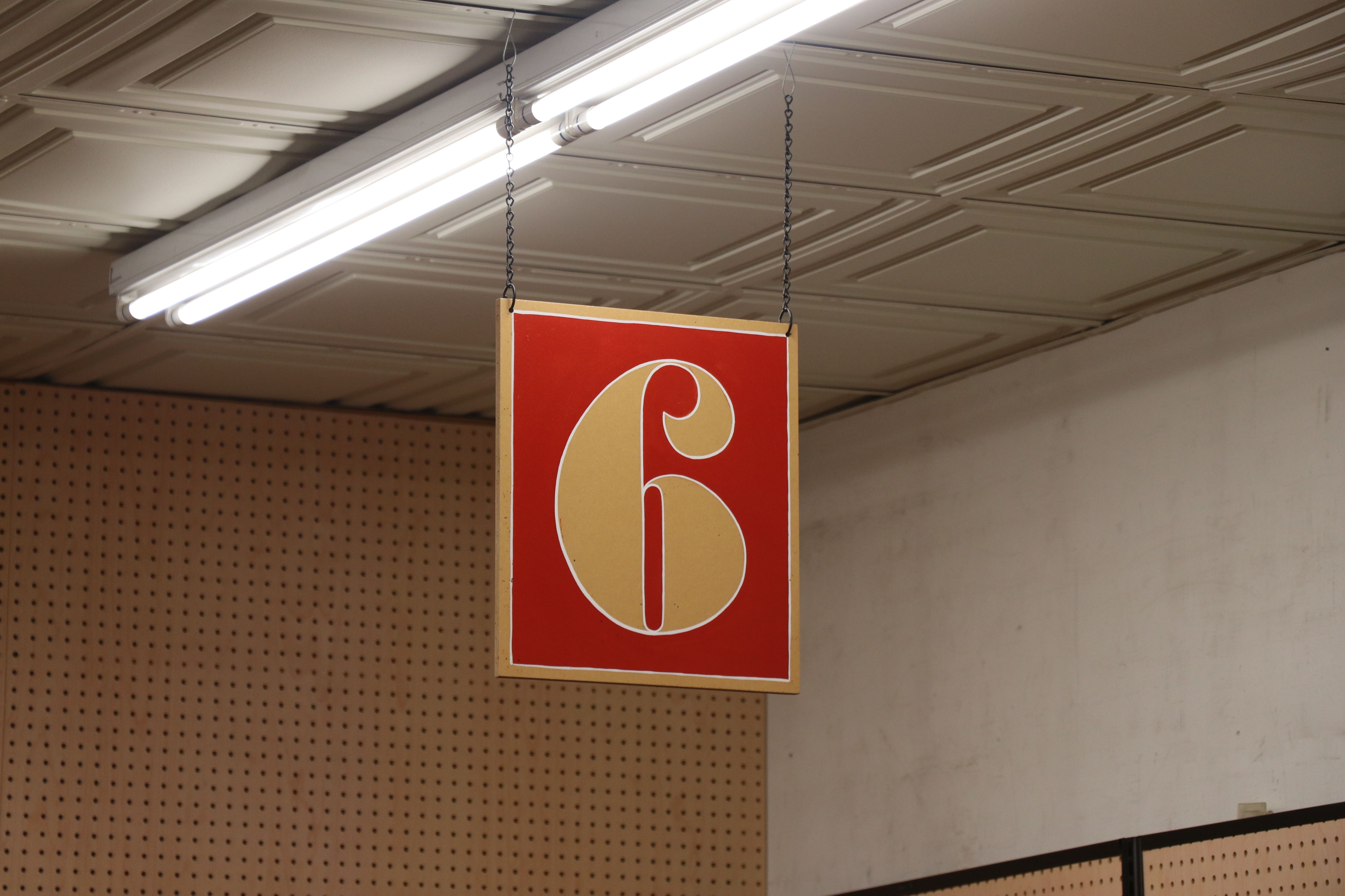 Number Six on Red Sign Hanging on Ceiling · Free Stock Photo