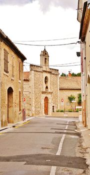 A quaint street scene featuring a historic stone building in Sallèles-d'Aude, Occitanie, France. — photo by Pierre Bastien