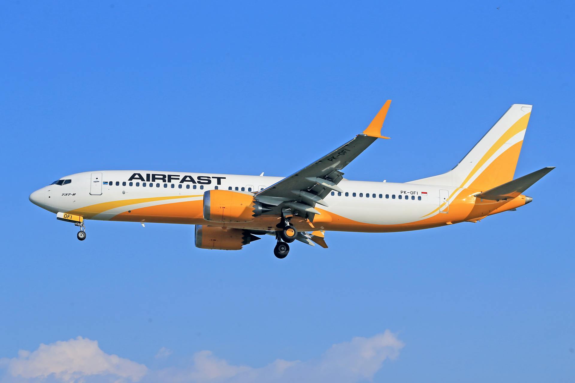 Airfast aircraft flying with blue sky backdrop, showcasing travel and aviation dynamics.