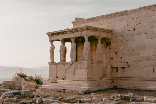Free View of the Erechtheion Caryatids at Athens' Acropolis during sunset, showcasing ancient Greek architecture. Stock Photo