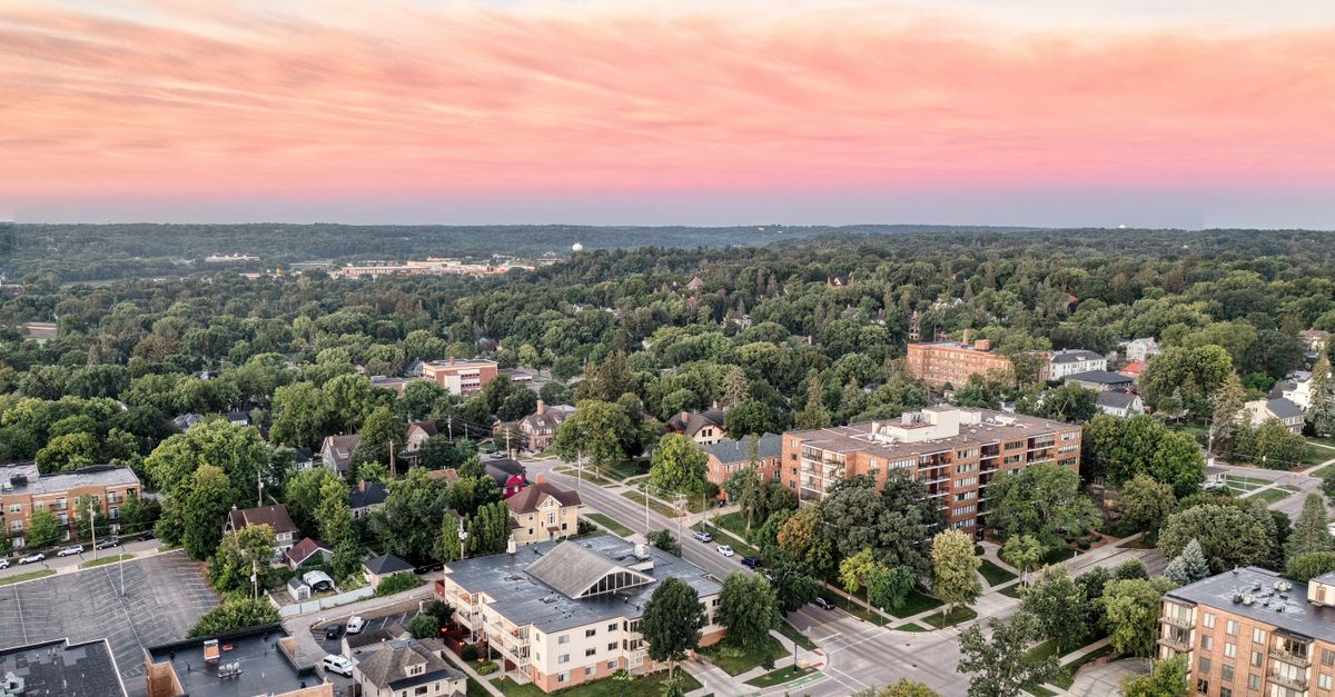 Explore a stunning aerial view of Rochester, Minnesota, featuring a vibrant cityscape and colorful sunset sky.