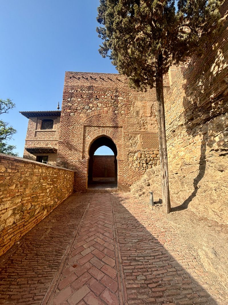 Moorish brick archway and patio inside the Alcazaba of Málaga