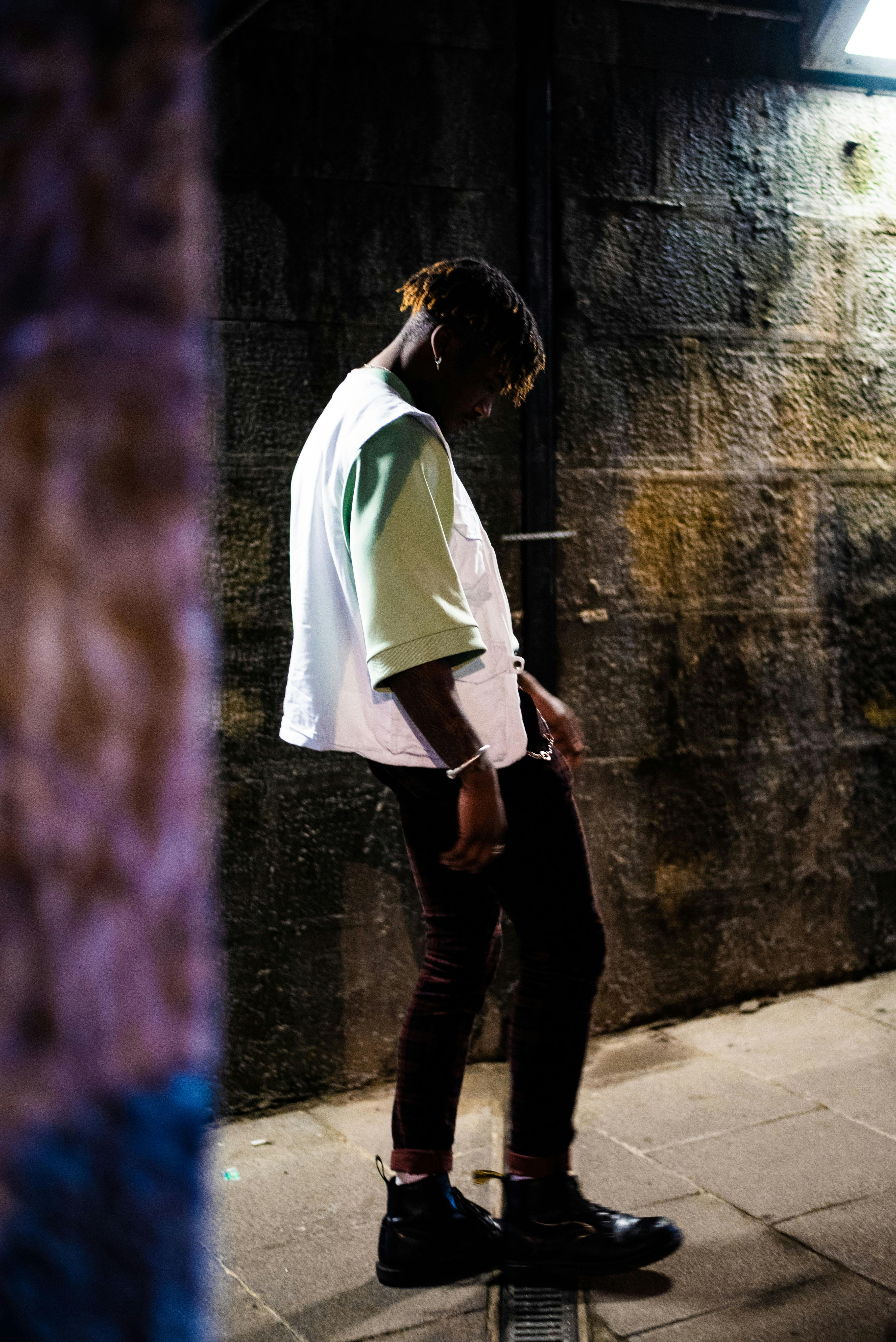 a man standing in a dark alleyway