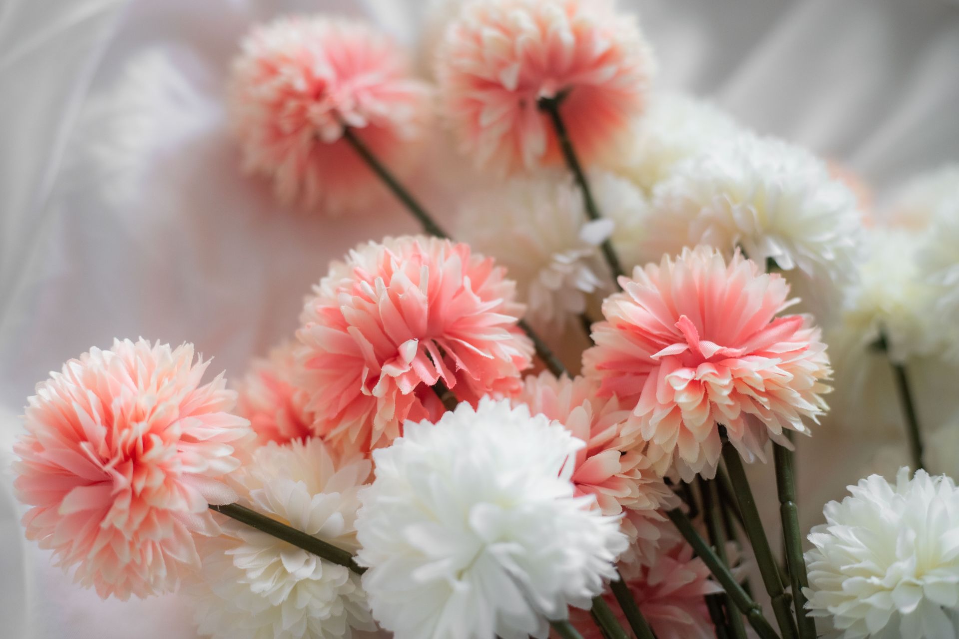 Delicate artificial flowers in pastel shades creating a serene indoors atmosphere.