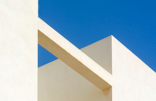 Free Minimalist architectural design showcasing geometric shapes against a clear blue sky. Stock Photo