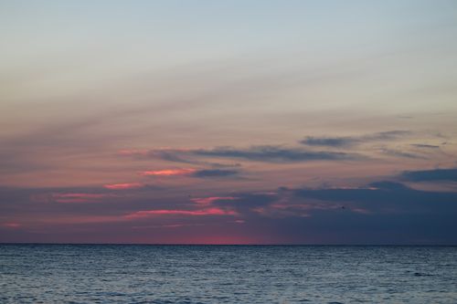 Free Tranquil sunset scene over Nantucket shoreline with vivid sky reflections. Stock Photo