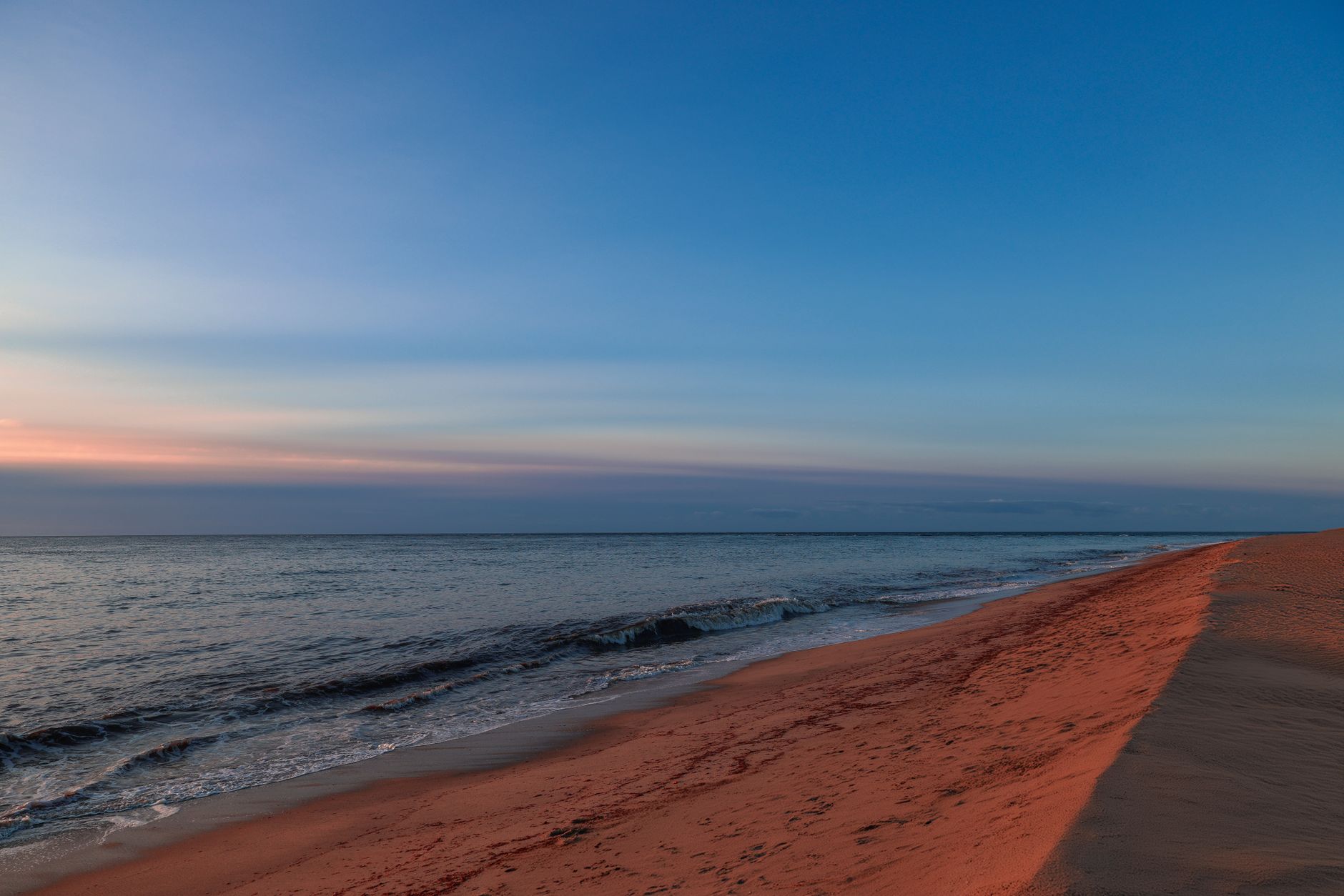 Discover the tranquil beauty of Sconset Beach at sunrise, Nantucket's serene shoreline.