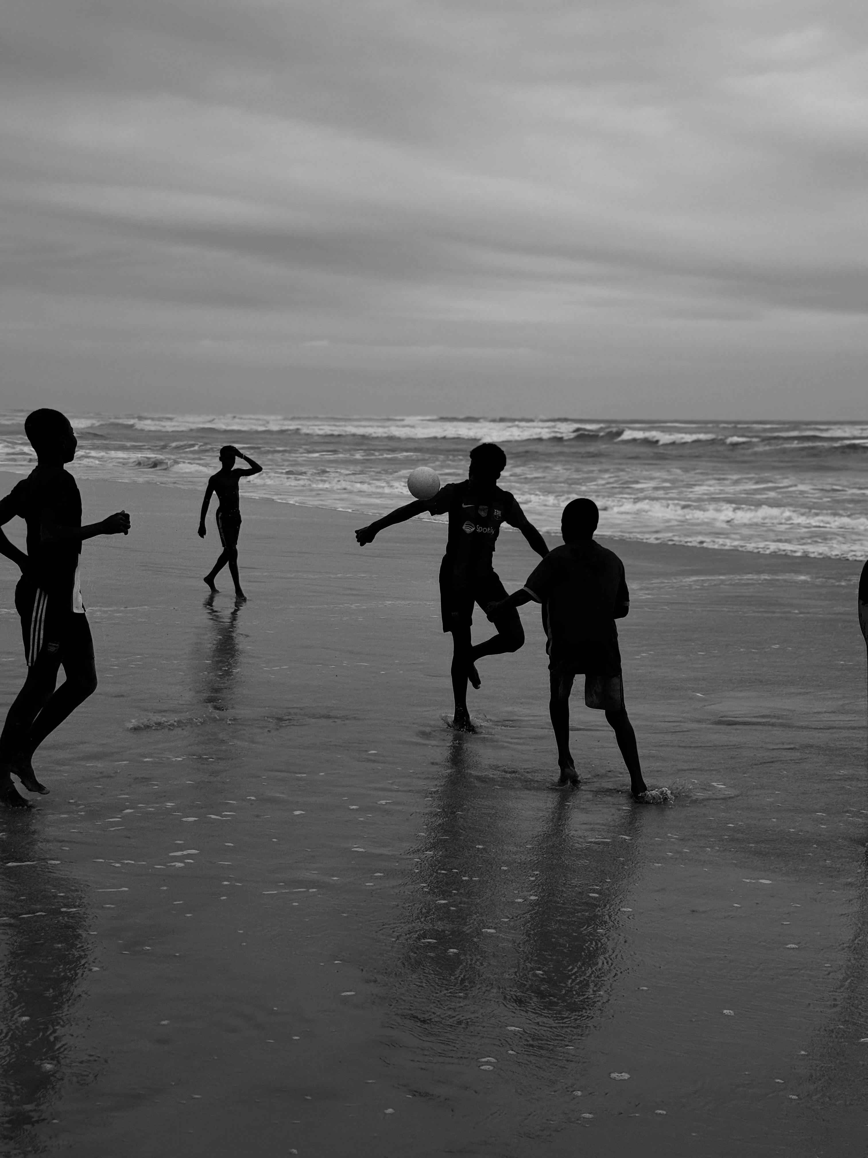 black and white african kids young boys and girls playing outside at the beach in abidjan west africa assinie beach near ghana